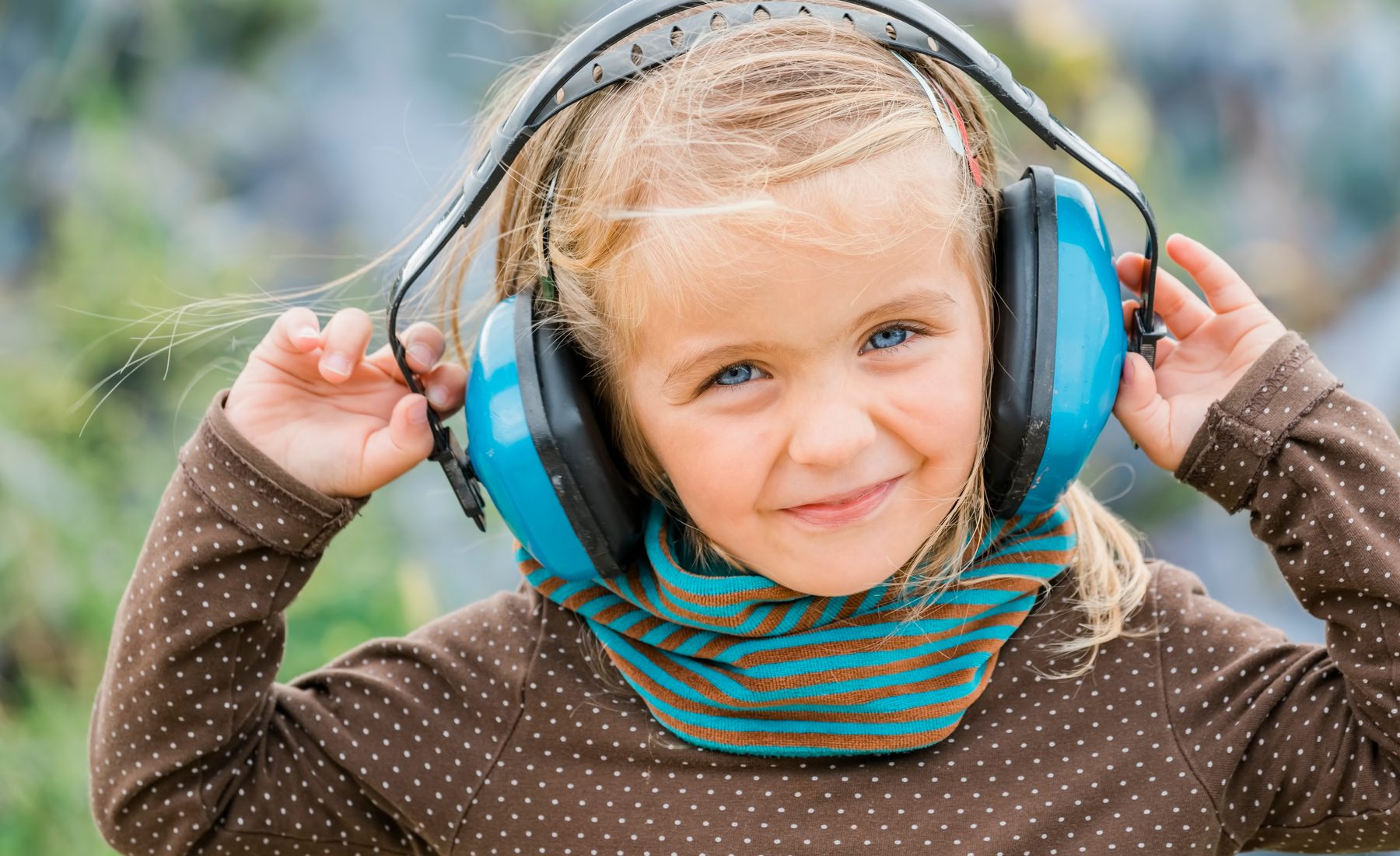 Child wearing ear defenders at a fireworks event