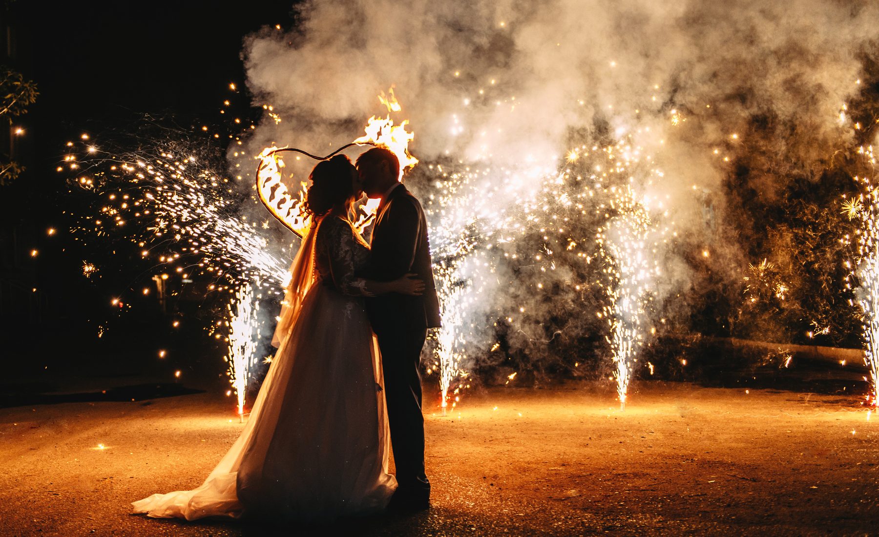 Bride and groom watching wedding fireworks